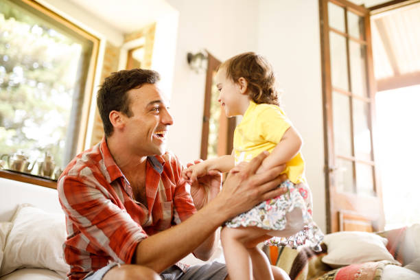 istock Father and daughter smiling at each other 1194610813