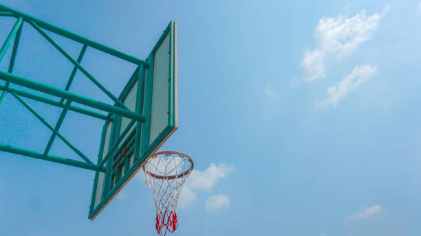 istock Basketball hoop and blue sky background 1194611903