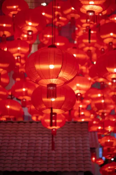 Photo of Traditional red lanterns decorated for Chinese new year Chunjie. Cultural festival in Shanghai. Bright Lush lava red background.