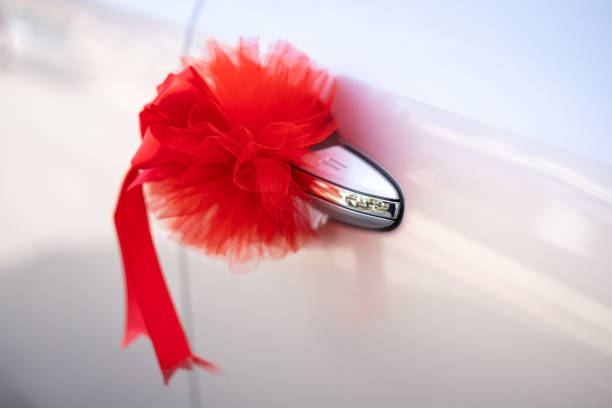 istock Red ribbon decoration on wedding car 1194617639