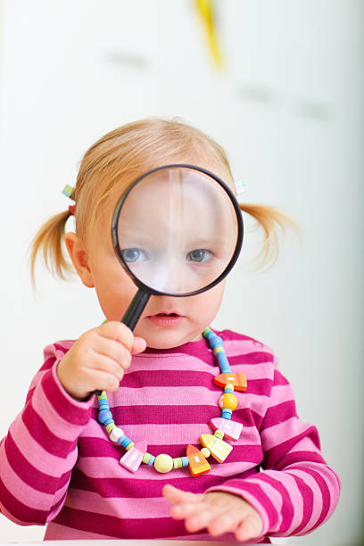 istock Toddler girl looking through magnifier 119461847