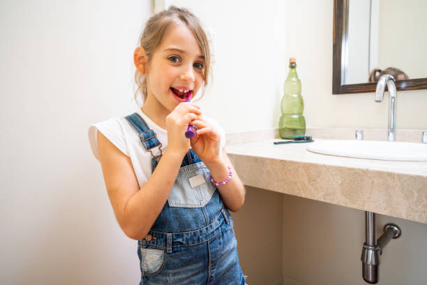 istock Little girl brushing her teeth 1194618702
