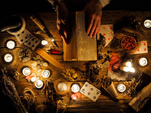 In the hands of fortune tellers old book with spells. The attributes of the occult In the hands of fortune tellers old book with spells. The attributes of the occult. curse stock pictures, royalty-free photos & images