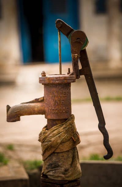 The water pump Siem Reap, Buddhist Temple, Down Town of the city, Cambodia, 22.11.2013 , A manual Water pump provided from the UNiCEF to the temple unicef vintage stock pictures, royalty-free photos & images
