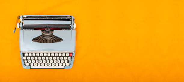 istock Old vintage style typewriter top view photo on yellow background 1194622063