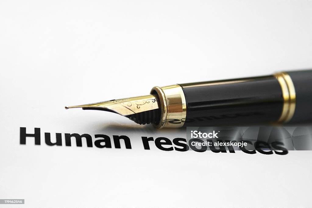 Old fashioned ink pen positioned above words Human Resources Close up of human resources concept. Black Color Stock Photo