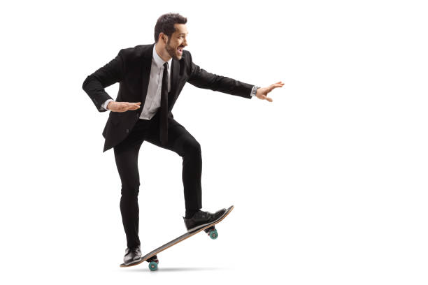 istock Businessman smiling and riding a skateboard 1194626636