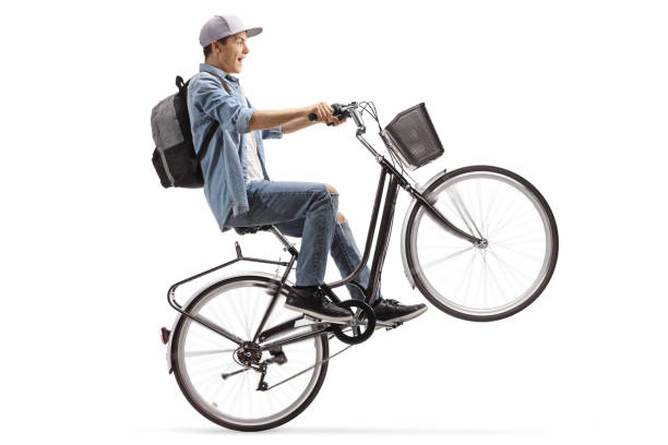 istock Male student riding a bicycle on one wheel 1194627953