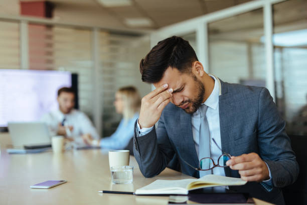 istock Young overworked businessman in the office 1194629262