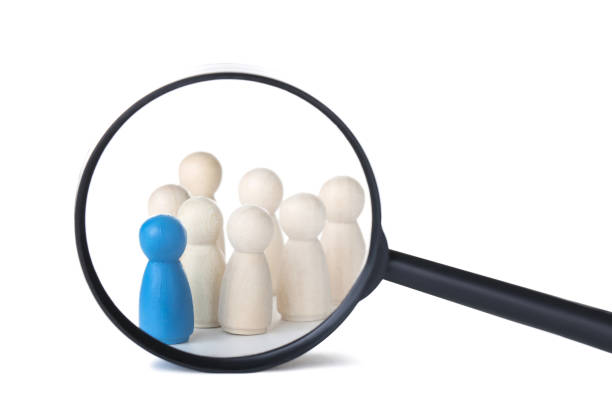 istock Leader concept. Wooden figures with loupe on white background 1194629422