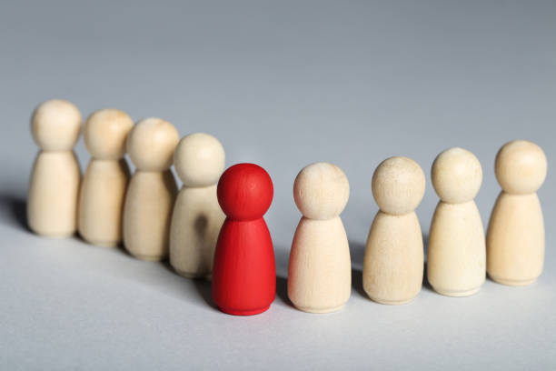 istock Leader concept. Wooden figures on gray background 1194629583