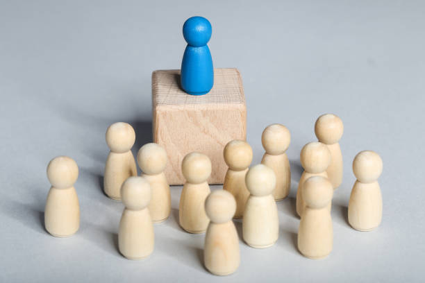 istock Leader concept. Wooden figures on gray background 1194629662