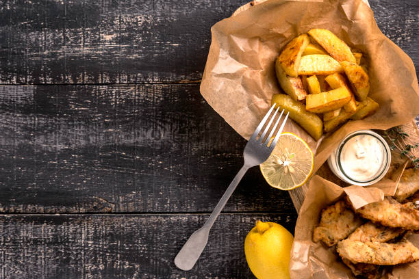istock Fish and chips on blue wooden table, British traditional food. 1194631987