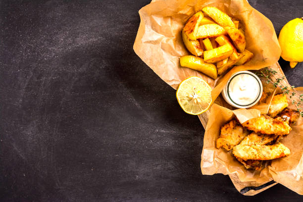 istock Fish and chips on blue wooden table, British traditional food. 1194631995