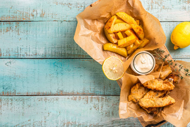 istock Fish and chips on blue wooden table, British traditional food. 1194631996