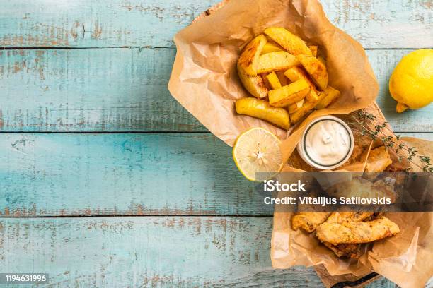Fish And Chips On Blue Wooden Table British Traditional Food Stock Photo - Download Image Now
