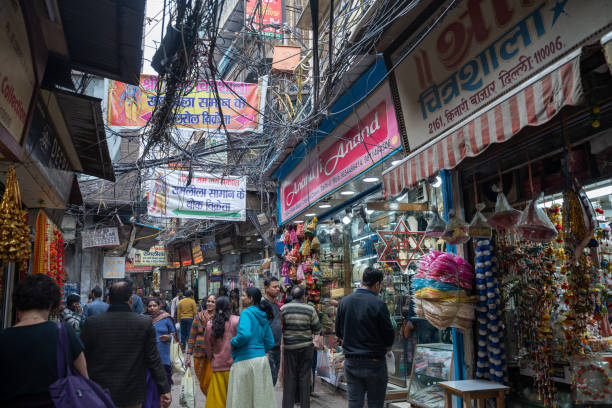 Crowded Chandi Chowk market in Old Delhi, people shopping for wedding attire and decorations in the market Delhi, India - December 14, 2019: Crowded Chandi Chowk market in Old Delhi, people shopping for wedding attire and decorations in the market old delhi stock pictures, royalty-free photos & images