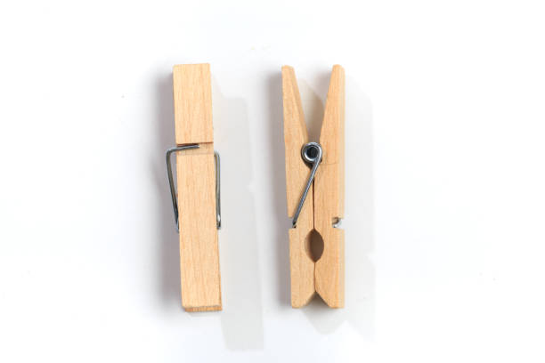 istock Brown wood clothes peg or clothespin on white background. 1194635494