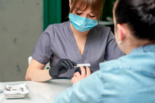 istock Manicurist makes manicure with nail file. 1194639165