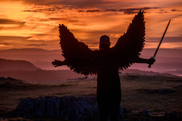 istock Black Winged Warrior Angel at dawn 1194641411
