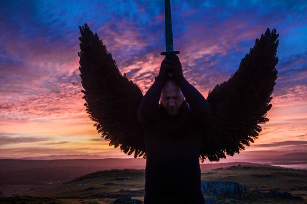 istock Black Winged Warrior Angel at dawn 1194641510