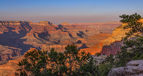 Sweeping photographs capturing the natural beauty of the Grand Canyon as the sun begins to set casting shadows and glowing colors on this geological wonder.