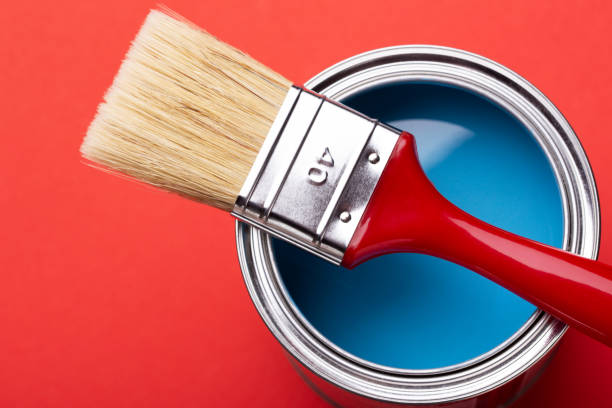 istock Can of blue paint on red. 1194641989