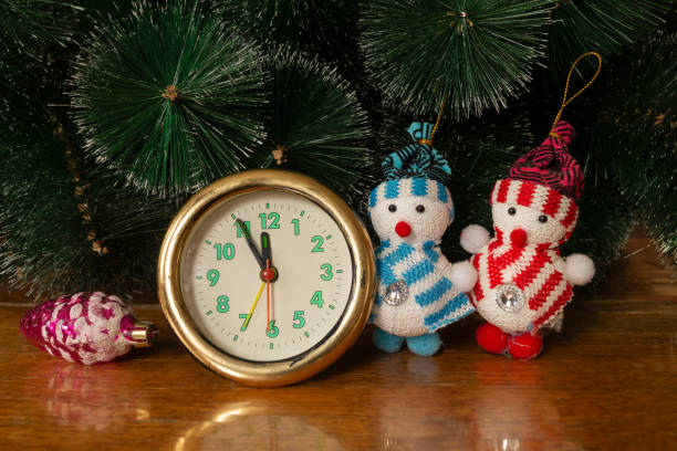 istock Watch with toy on table under fir tree in Cristmas 1194642570