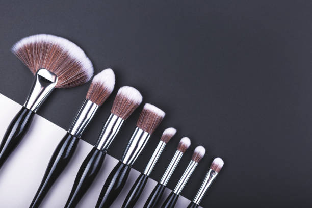 istock Set of makeup brushes on black and grey color block background. 1194642771