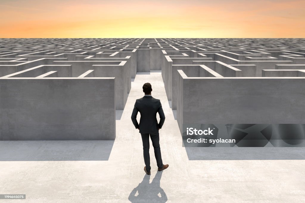 Businessman at the entrance of a complex maze Solution concept with a businessman at the entrance of a complex maze, Digitally Generated Image. Maze Stock Photo