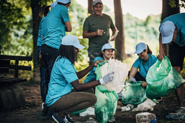 istock People cleaning the environment in nature 1194645177