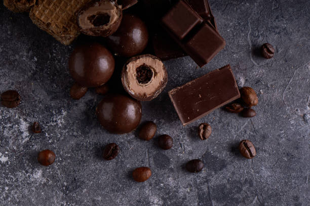 istock broken black and white chocolate. Pieces of chocolates on a gray stone table 1194645248
