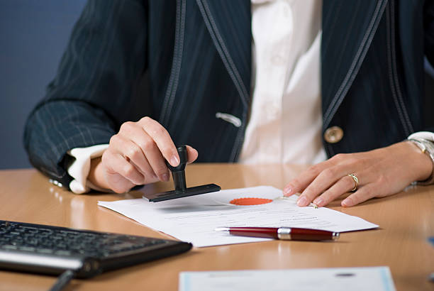 istock businesswoman stamping document 119464555