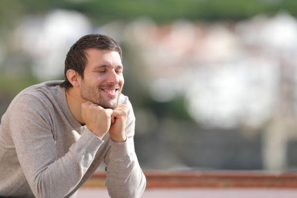istock Happy man with closed eyes enjoying the sun 1194645839