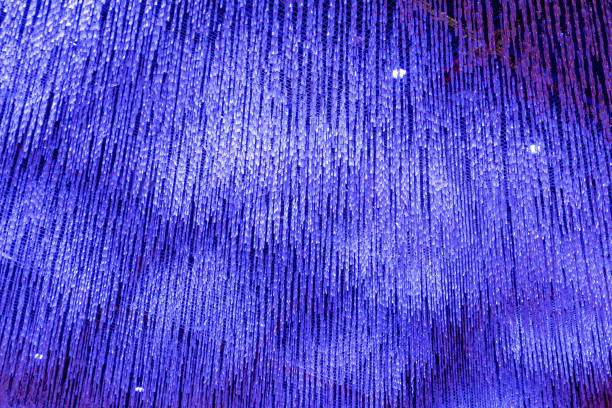 istock Glass garlands hanging from ceiling in vivid ultraviolet light 1194647465