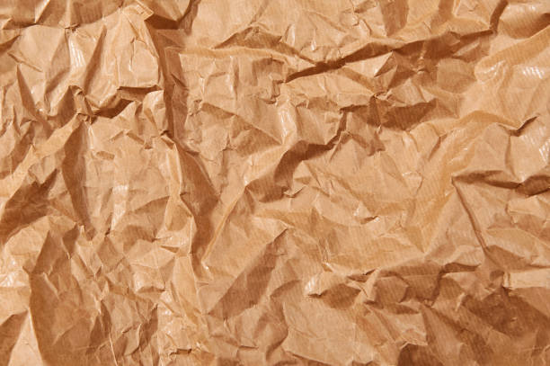 istock Brown crumpled paper textured background. Close up. 1194648559