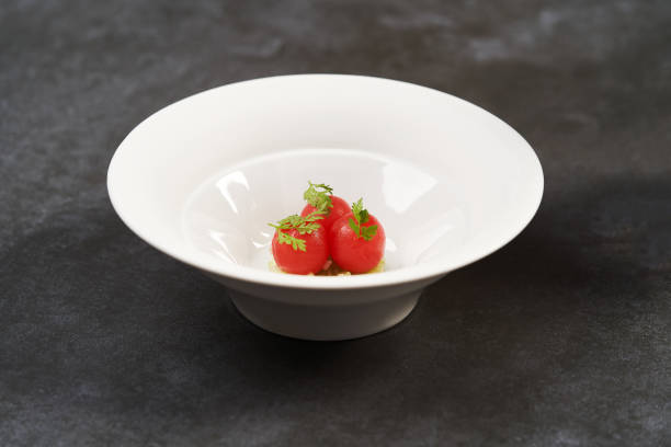 istock Fresh peeled chili tomatoes and minced cucumbers on dark background 1194648995