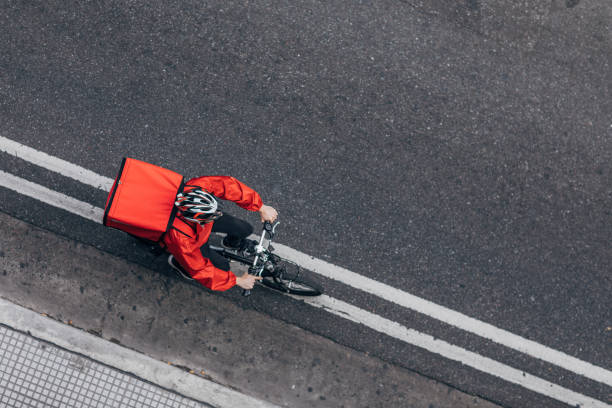 Pizza delivery guy on bicycle One man, delivery boy on bicycle, delivering pizza in city. food delivery stock pictures, royalty-free photos & images