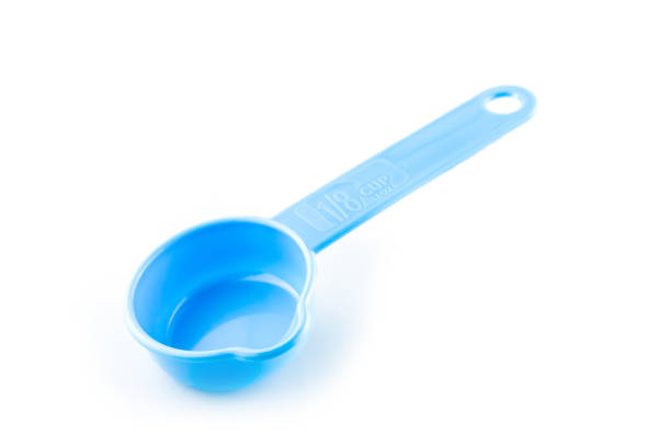 istock measuring spoon of plastic on white background. 1194650472