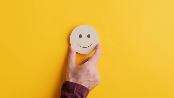 istock Wooden cut circle with smiling face on it 1194650636