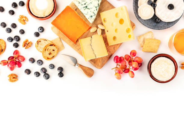 istock Cheese platter background with a place for text, a flat lay overhead shot on white. Blue cheese, goat cheese, Brie and other sorts with fruits, nuts and almonds, a design template 1194651523