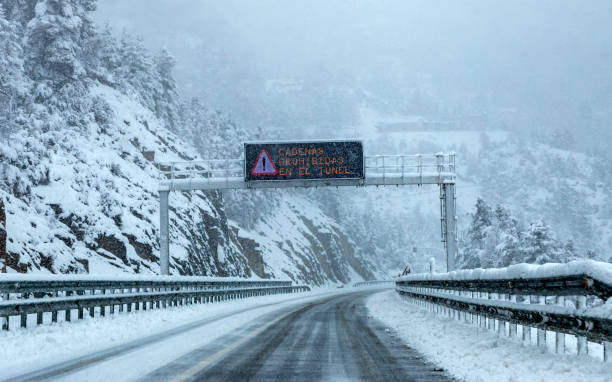 istock Blizzard in a mountain road 1194651892