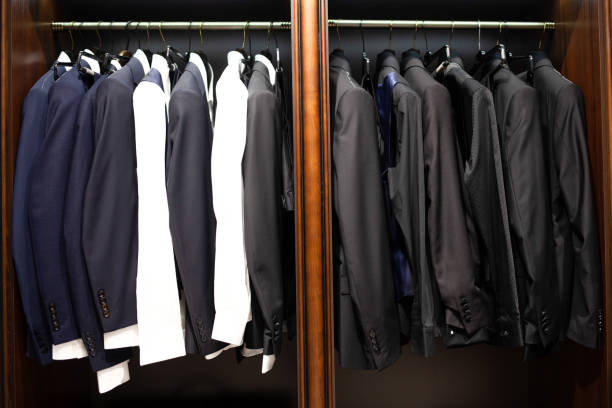 istock Many men's suits on a hanger in the store 1194653246