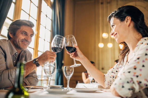 istock Modern couple drinking red wine in restaurant 1194654160