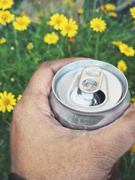 istock Cola can on hand and flower 1194655292