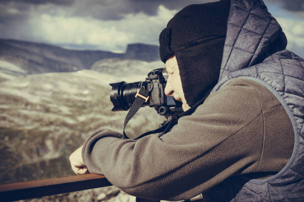 istock Tourist taking photo in norwegian mountains 1194655368