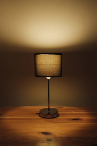 istock Electric lamp on the table top, natural low key light. 1194655464
