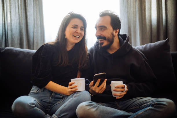 istock Couple looking at mobile phone at home 1194655471