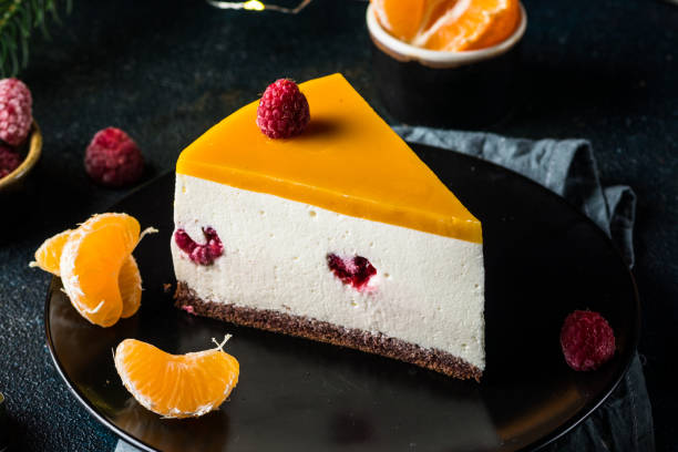 creamy mascarpone cheese cake. new york cheesecake. christmas dessert. healthy food. creative atmospheric decoration. candles. mango, raspberry cake. piece of cake. new year dessert - raspberry table wood autumn imagens e fotografias de stock