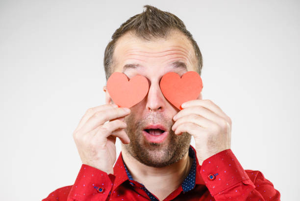 istock Man in love with hearts on eyes 1194656739